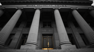 Exterior of the Milwaukee County Courthouse steps, black and white with a gold accent on the brass door handle.